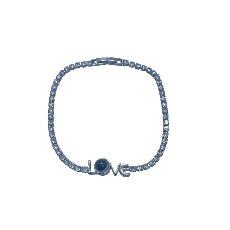 AURA Delicate silver zircon bracelet with sparkling crystals and the word love at the center – a graceful symbol of affection. - Aura